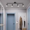 A hallway with doors and a coat rack, illuminated by a ceiling light fixture. Produktbild-Vorschau