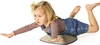 A young girl is lying on a balance board. Anteprima dell’immagine prodotto