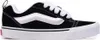 A side view of a black Vans sneaker with white laces and a white sole. Voir les images du produit