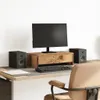 A desk setup with a monitor stand, monitor, keyboard, and speakers. Podgląd zdjęcia produktu