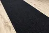 A dark gray ribbed runner rug placed on a light brown wooden floor. Produktbild-Vorschau