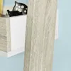 A close-up view of a shelf with a small decorative house and a black and white spotted object on it. The shelf is made of wood and white material, and it is placed against a blue background. Podgląd zdjęcia produktu