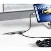 A USB hub connected to a monitor and a keyboard on a desk. Produktbild-Vorschau