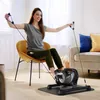 A woman is exercising with a mini-heimtrainer in a living room. Náhľad obrázku produktu