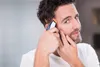 A man is trimming his hair with an electric hair clipper. Produktbild-Vorschau