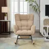 A beige corduroy rocking chair with a headrest is shown in a living room setting, next to a side table with a lamp and a window with curtains. A plant is visible in the background. Náhľad obrázku produktu