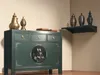 A dark green Asian-style sideboard with decorative elements, placed in a room with a shelf above it holding decorative vases. Produktbild-Vorschau