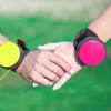 Two people holding hands, each wearing a dog leash device on their wrist. Podgląd zdjęcia produktu