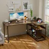 A modern L-shaped computer desk with shelves, set up in a home office or gaming room. It features a computer, monitor, laptop, and desk accessories. Náhľad obrázku produktu