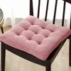 A pink seat cushion on a dark chair. Produktbild-Vorschau