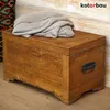 A wooden chest with a folded blanket on top, placed against a textured wall. Náhled obrázku produktu