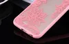A close-up shot of a pink phone case with a lace-like floral pattern. Produktbild-Vorschau
