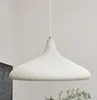 A pendant lamp hangs from a white cord against a light gray and white background. Produktbild-Vorschau