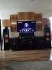 A home entertainment setup with a TV, sound system, and acoustic wall panels. Podgląd zdjęcia produktu