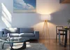 A modern living room with a sofa, coffee table, and a floor lamp. Produktbild-Vorschau