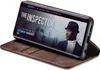 A smartphone in a brown flip case is displayed, showing a movie poster on its screen. Produktbild-Vorschau