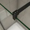 A close-up view of a shower enclosure corner, showing the black metal frame and green tinted glass. Produktbild-Vorschau