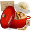 A collection of items for baking bread, including a Dutch oven, a proofing basket with dough, and a recipe book. Voir les images du produit