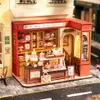 A miniature model of a French-style dessert shop with detailed interior and exterior elements. Podgląd zdjęcia produktu