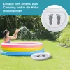 A young woman is playing in an inflatable pool in a backyard setting. There is also a smaller inflatable foot basin in the foreground. Produktbild-Vorschau
