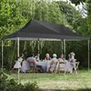 A group of people are gathered around a table under a black canopy tent in a garden setting. Podgląd zdjęcia produktu