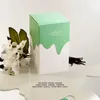 A perfume box with decorative elements and scent notes listed. Anteprima dell’immagine prodotto