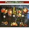 A collection of illuminated Christmas-themed window decorations, including Santa Claus, a snowman, a Christmas tree, and a train, displayed against a dark background. Náhled obrázku produktu