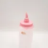A pink and white bottle with a dispenser top. Anteprima dell’immagine prodotto