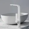 A white matte faucet is shown in front of a white basin, both resting on a marble countertop. Podgląd zdjęcia produktu