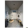 A modern hallway with a black cabinet, a white chair, a wooden bench, and a door. Produktbild-Vorschau