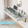 A white floating vanity desk with multiple drawers and compartments, organized with various makeup and beauty products. A round illuminated mirror is mounted on the wall above the desk. Voir les images du produit