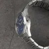 A close-up side view of a silver analog watch with a blue face. Náhled obrázku produktu