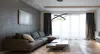 A modern living room with a sectional sofa, coffee table, and a large window with curtains. Náhled obrázku produktu