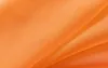A close-up view of draped orange fabric, likely a curtain or textile. Produktbild-Vorschau