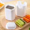 A kitchen utensil for slicing vegetables, with sliced carrots and cucumbers on a wooden board. Produktbild-Vorschau