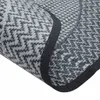 A close-up view of a grey outdoor rug with a black border. Produktbild-Vorschau