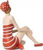 A figurine of a woman in a vintage swimsuit sitting on the floor. Voir les images du produit