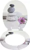 A toilet seat with a design of stacked stones and a purple flower. Produktbild-Vorschau