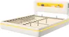 A bed frame with a slatted base and a headboard with built-in shelving and lighting. Produktbild-Vorschau