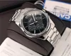 A close-up shot of a men's Casio watch with a black dial and silver metal band, placed on a brown watch stand. A warranty card and a blue Casio box are visible in the background. Produktbild-Vorschau