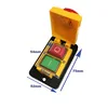 A yellow and black industrial switch with red and green buttons, shown with dimensions indicated by blue arrows and text. Produktbild-Vorschau