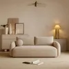 A modern living room scene featuring a sofa, a cabinet, and decorative items. Voir les images du produit