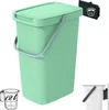 A green trash can with a lid and handle, shown with a measuring cup and a weight indicator. Náhľad obrázku produktu
