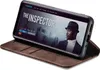 A smartphone in a brown flip case, displaying a movie poster on its screen. Produktbild-Vorschau