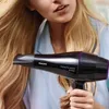 A woman is holding a black Philips hairdryer near her blonde hair. Náhled obrázku produktu