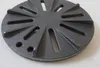A close-up, slightly angled view of a round, cast iron grate with radiating slots and two small holes near the edge, resting on a light gray surface. Anteprima dell’immagine prodotto