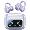 A pair of purple clip-on Bluetooth earbuds and their charging case are displayed against a white background. Produktbild-Vorschau