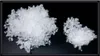 Two piles of white fluffy material on a black background. Náhľad obrázku produktu