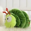 A plush caterpillar toy lying on a fluffy white surface. Produktbild-Vorschau