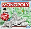 The image shows the front of a Monopoly board game box, featuring the game's iconic characters and tokens. Náhled obrázku produktu
